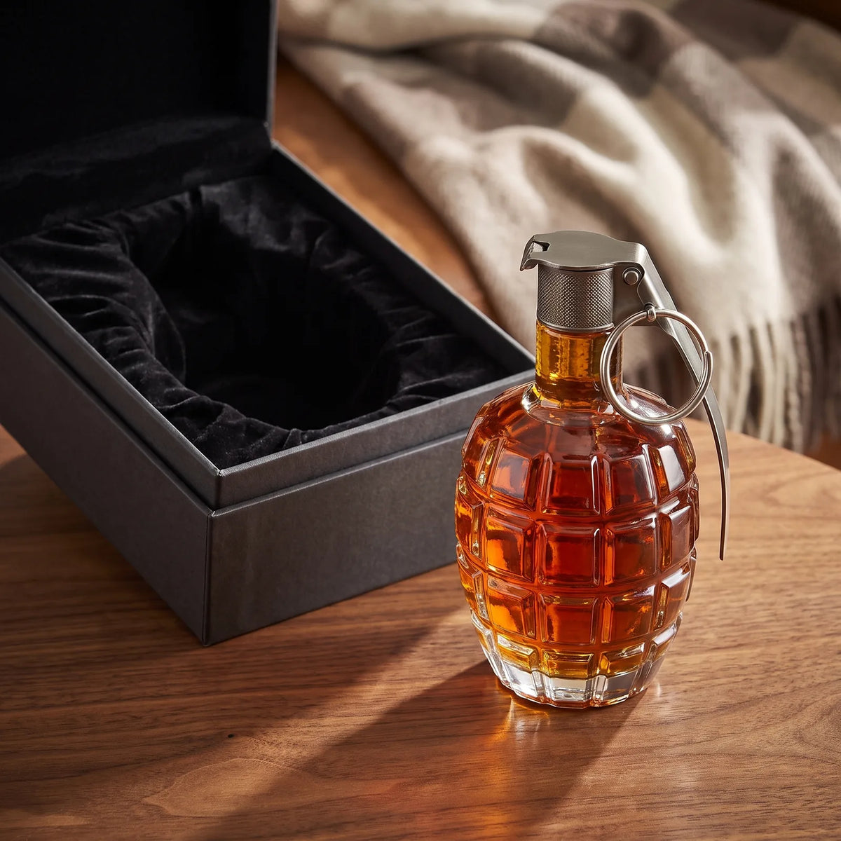 Grenade Whiskey Decanter beside an open gift box