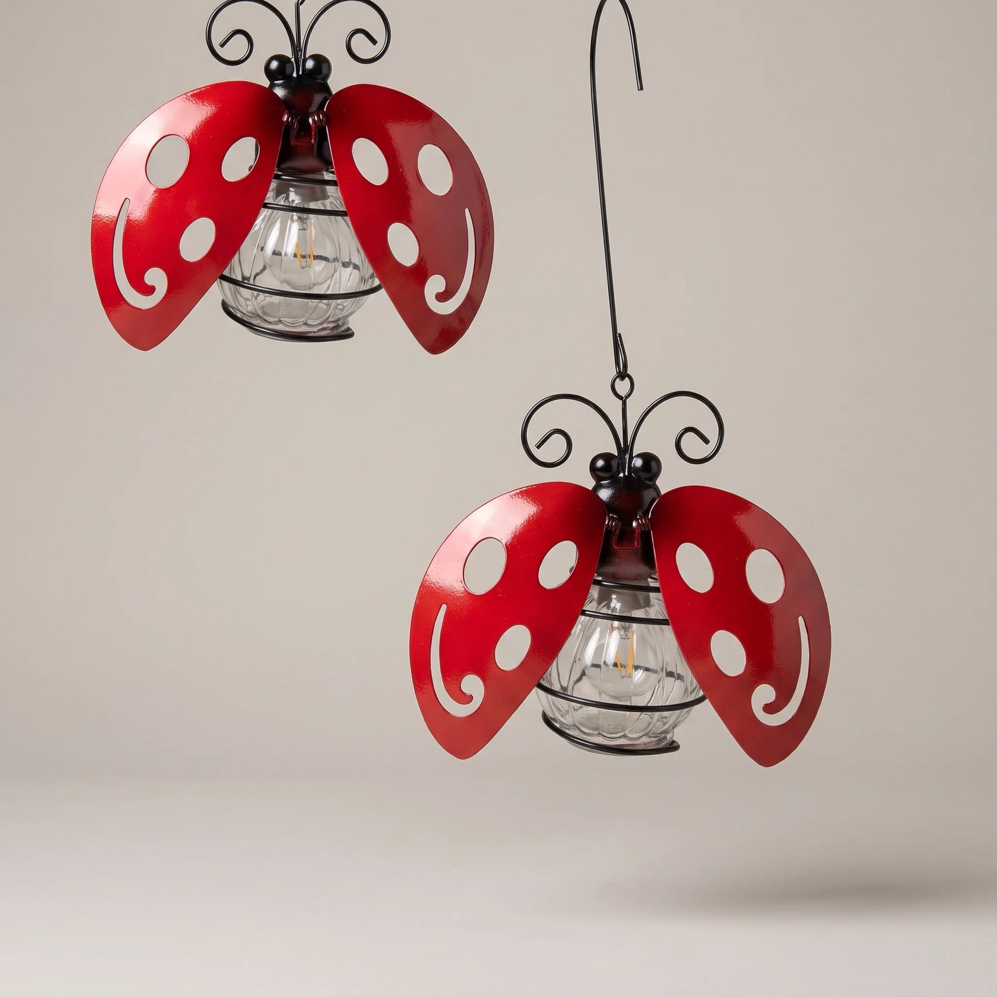 Solyra solar ladybug light with red enamelled wings, studio product photo