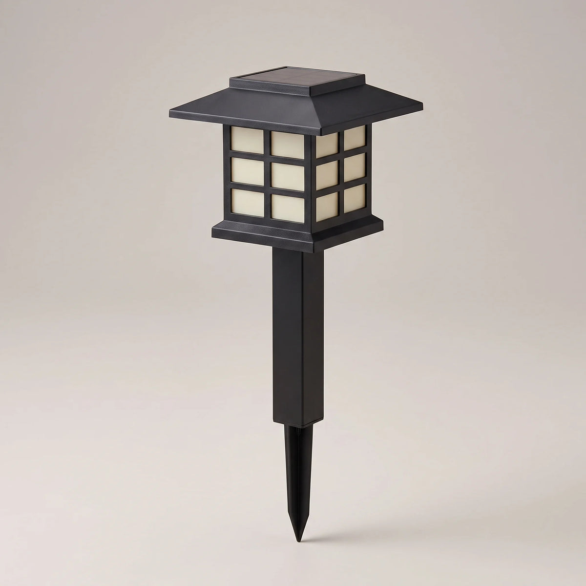 Single black square lantern solar path light on its ground stake, studio shot