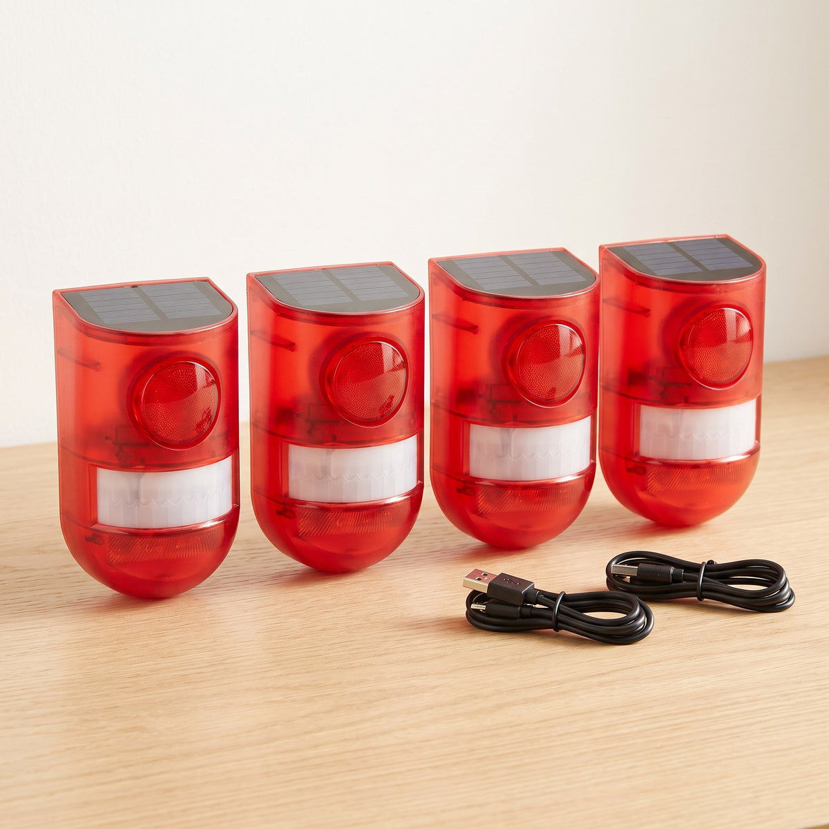 Four solar motion alarms with USB charging cables