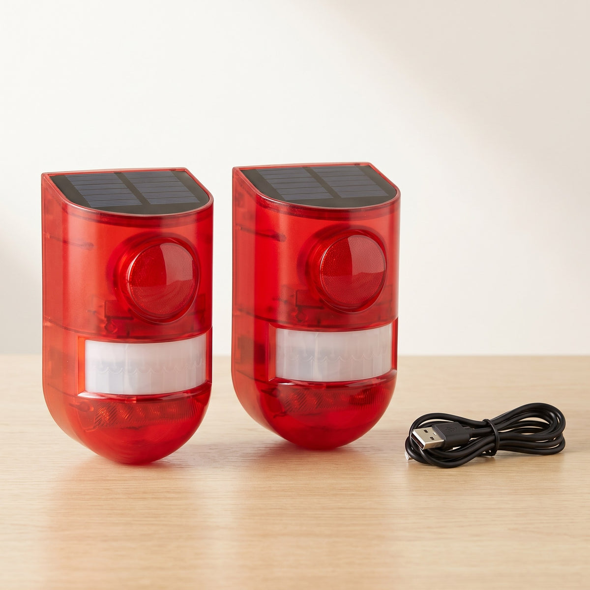 Two solar motion alarms with USB charging cable