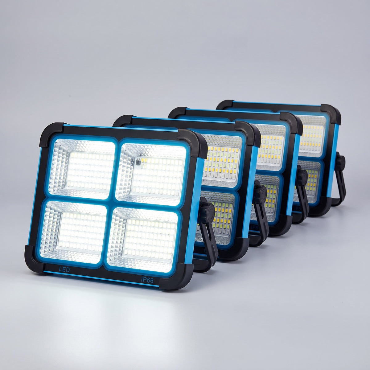 Four blue solar LED work lights in a staggered studio row, the nearest one lit