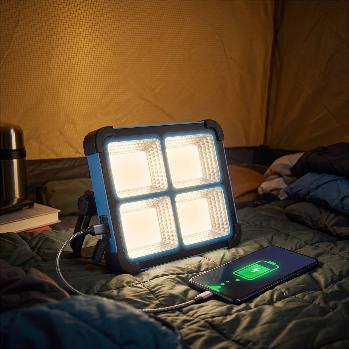 Work light charging a phone over USB-C inside a tent at night