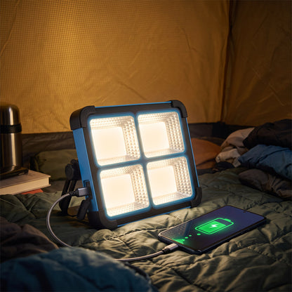Work light charging a phone over USB-C inside a tent at night
