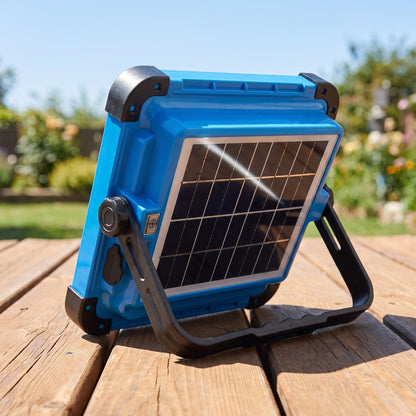 Back of the work light on a sunny deck rail, solar panel angled at the sun