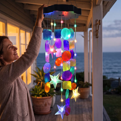 Hanging the solar seashell chime from a porch hook at dusk