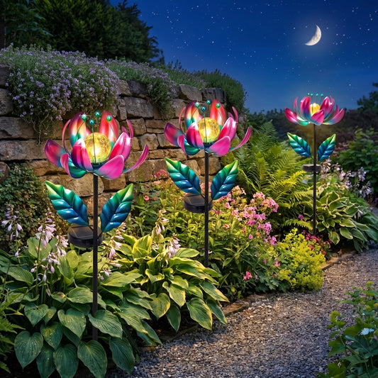 Metal lotus windmill glowing at dusk