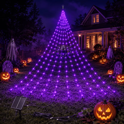 Purple solar spider web light lit on a lawn with the solar panel and cable visible in the foreground