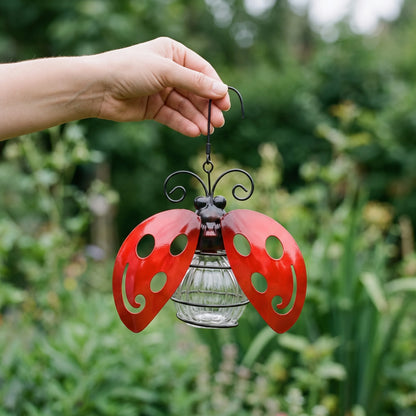 Hand holding the solar ladybug light to show its true size