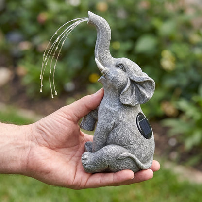 Solar elephant garden light held in one hand for scale