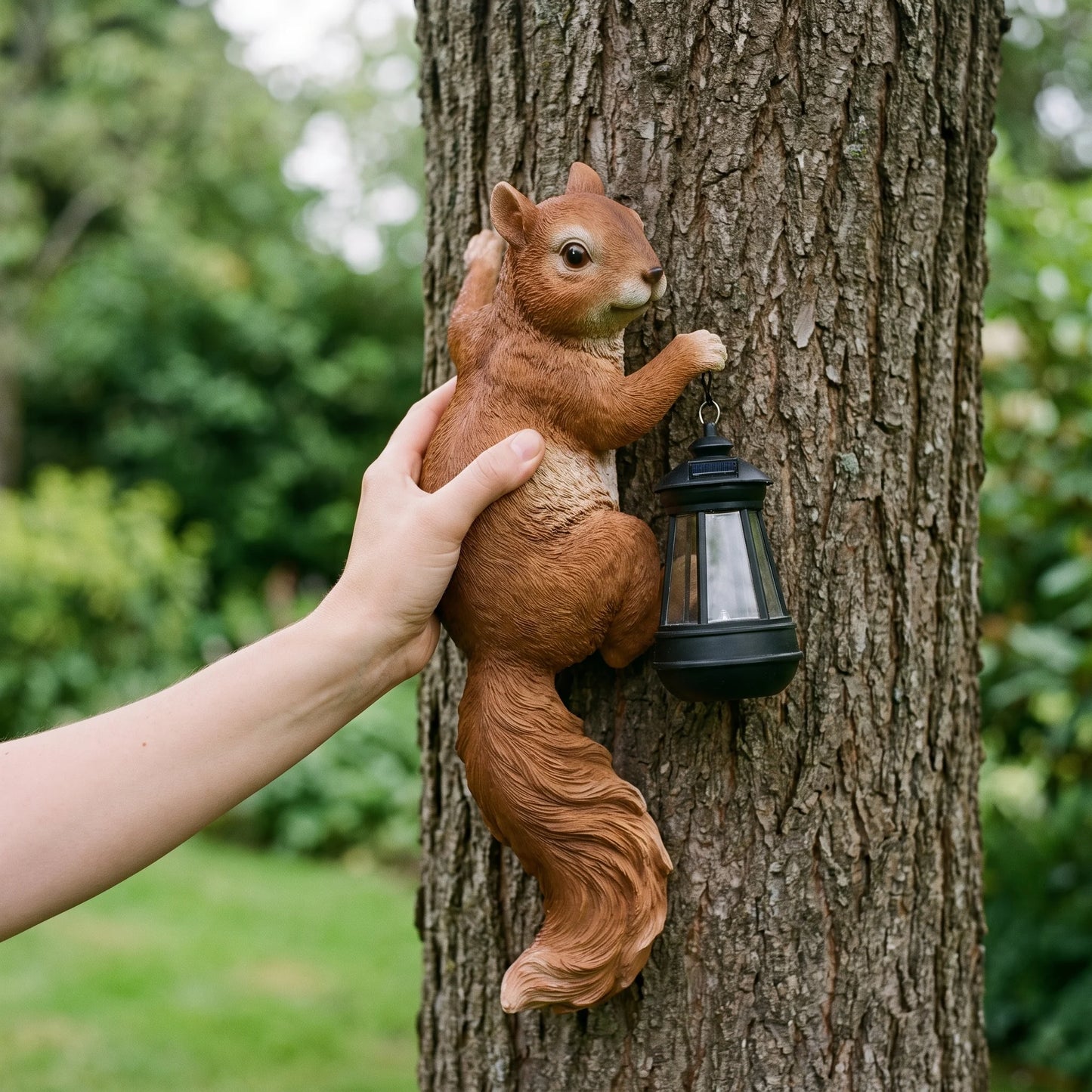 Hand holding the solar squirrel lantern to show its true size