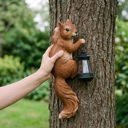 Hand holding the solar squirrel lantern to show its true size