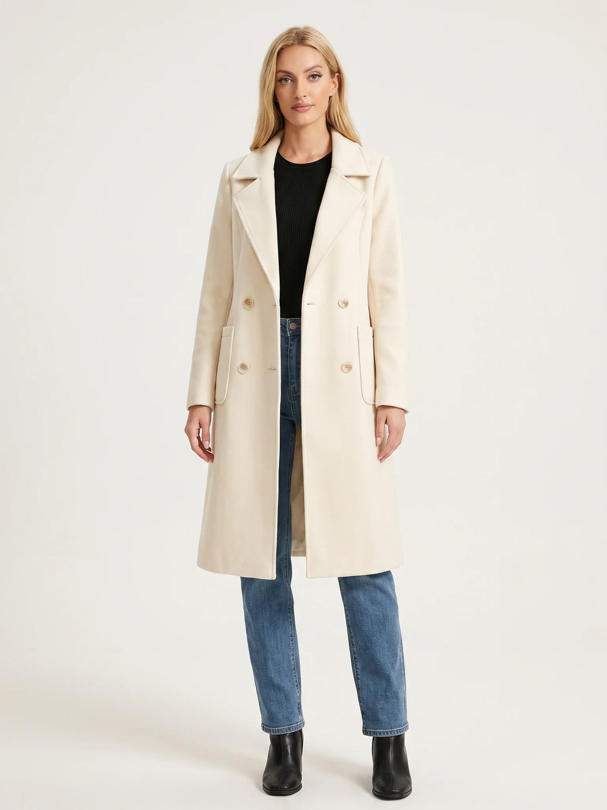 The Ivory wool-blend coat worn open on a model, photographed from the front in a studio