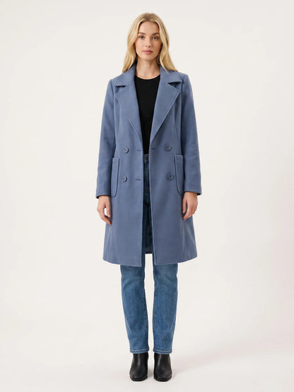 The Dusty Blue wool-blend coat worn open on a model, photographed from the front in a studio