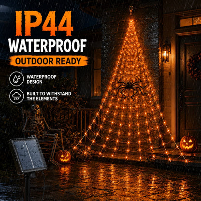 IP44 waterproof: the orange solar spider web light lit on a wet stone wall during heavy rain