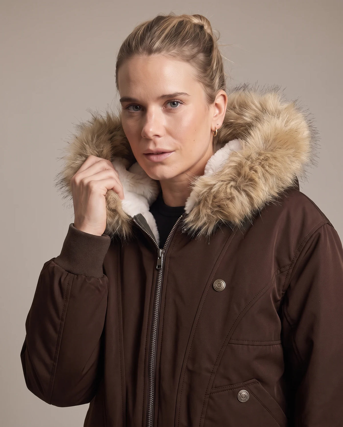 Close view of the mocha brown jacket's faux fur hood trim and ivory shearling collar