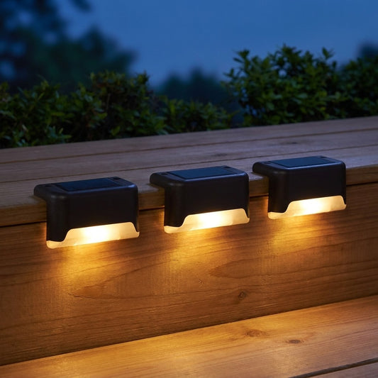 Solar powered deck lights glowing warm white along a wooden deck step at dusk