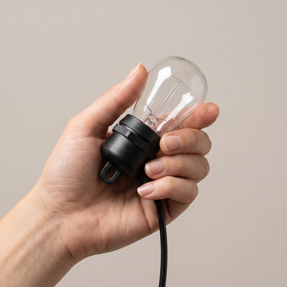 Adult hand holding one bulb and socket to show its real size