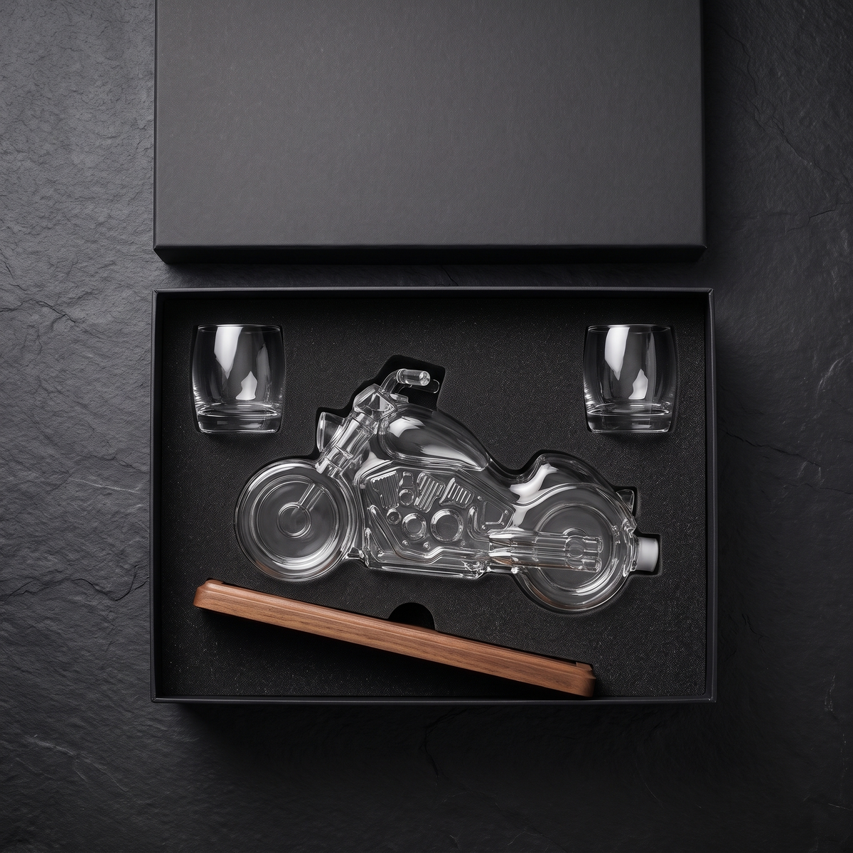 The set packed in its black foam-fitted gift box with the two glasses and wooden stand