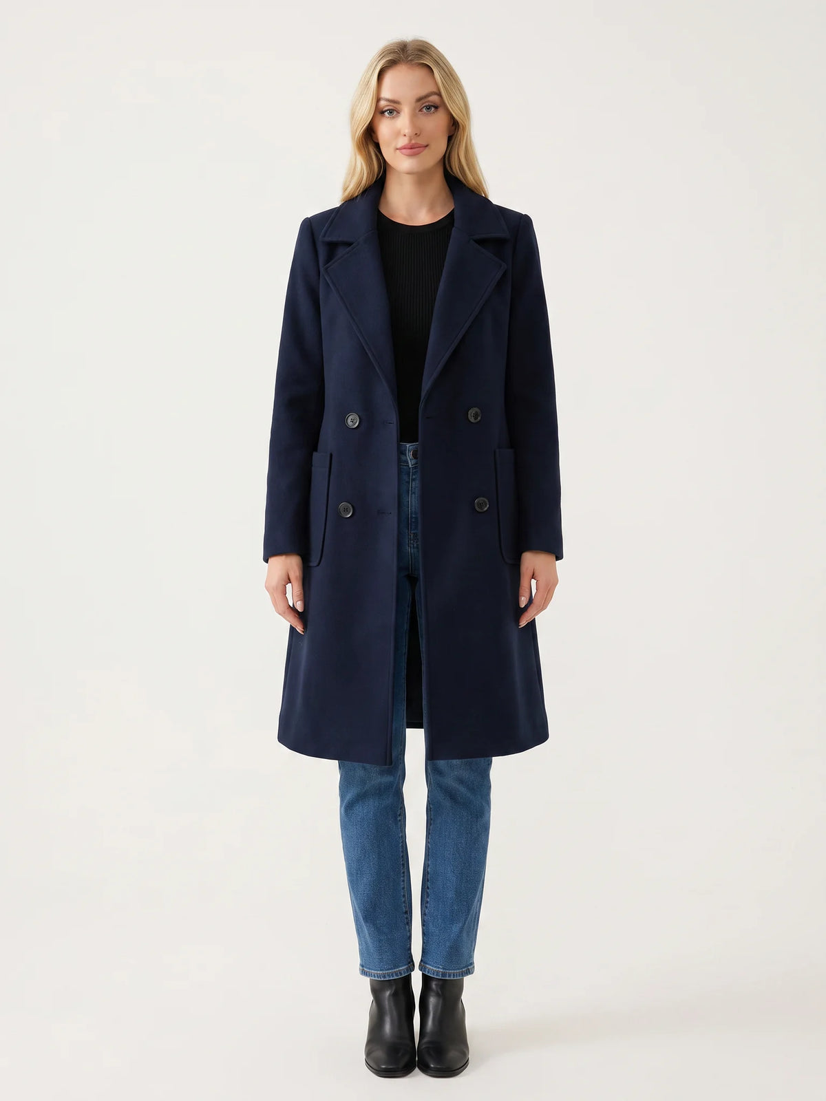 The Navy wool-blend coat worn open on a model, photographed from the front in a studio
