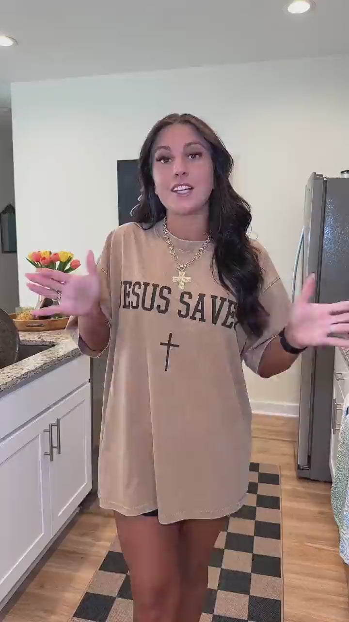 Customer try-on of the Jesus Saves tee in khaki, also showing the washed blue