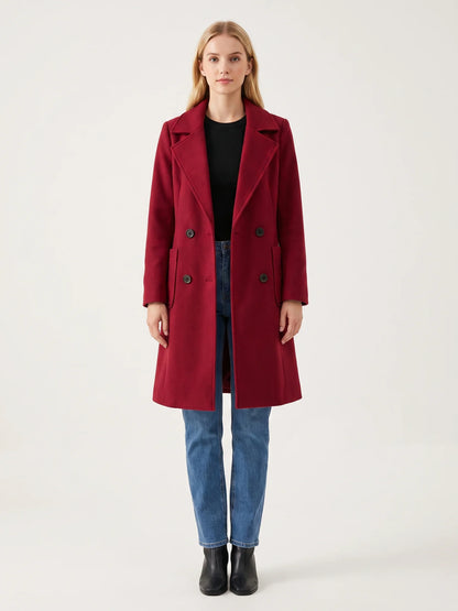 The Crimson wool-blend coat worn open on a model, photographed from the front in a studio