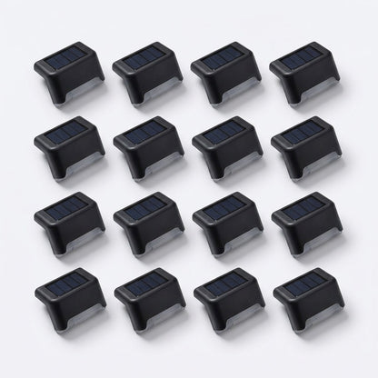 All 16 matte black solar deck lights from the 16 pack laid out on white